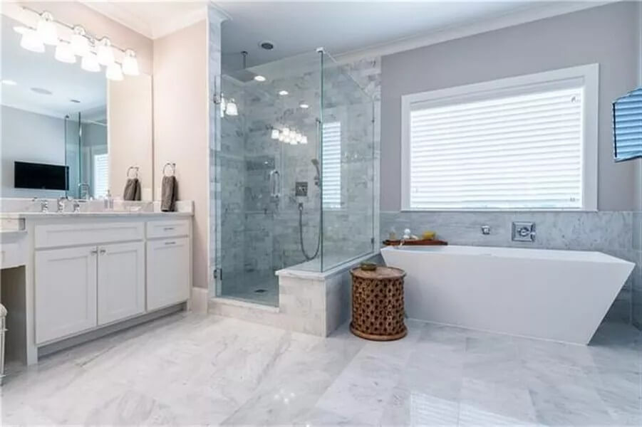 Primary bathroom with a large vanity, a walk-in shower, and a soaking tub.