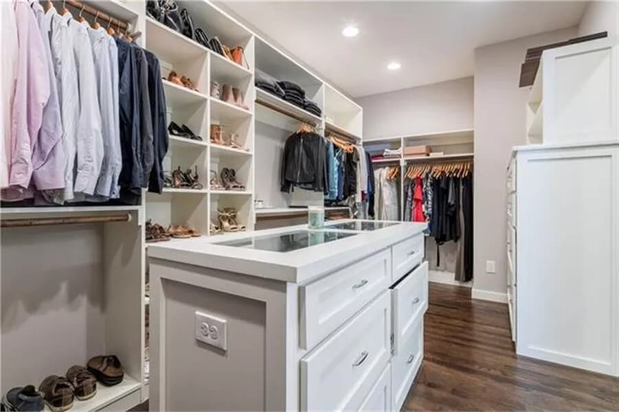 Primary walk-in closet with ample storage and an island.