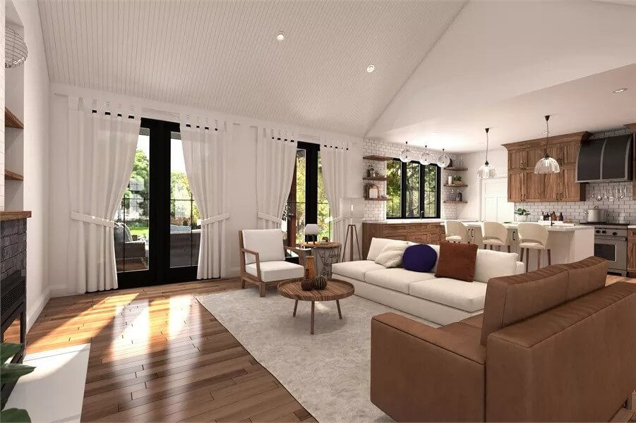 The living room includes a round coffee table and two sets of French doors that open to a covered terrace.