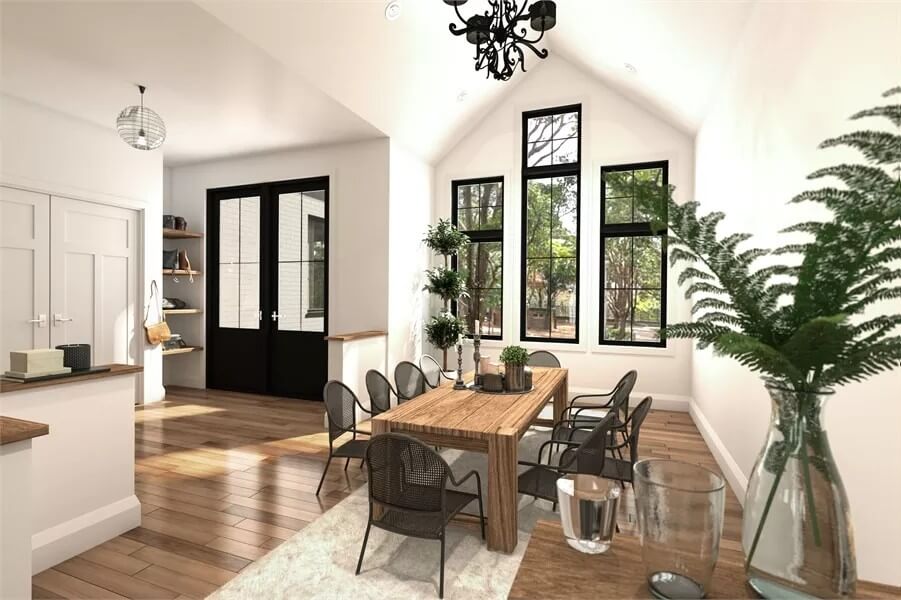 Dining room with a wooden dining set under a cathedral ceiling.