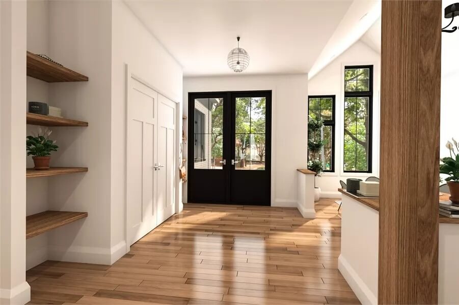 Foyer with a French front door and built-in shelves.