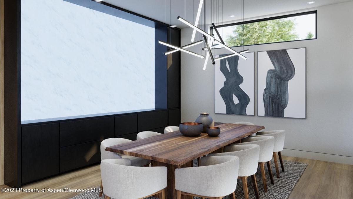 Dining room with a large wooden table and chairs.