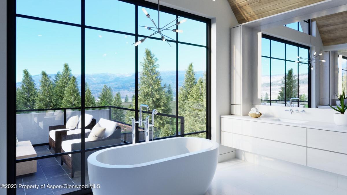 Bathroom with a soaking tub, sink and mirror.