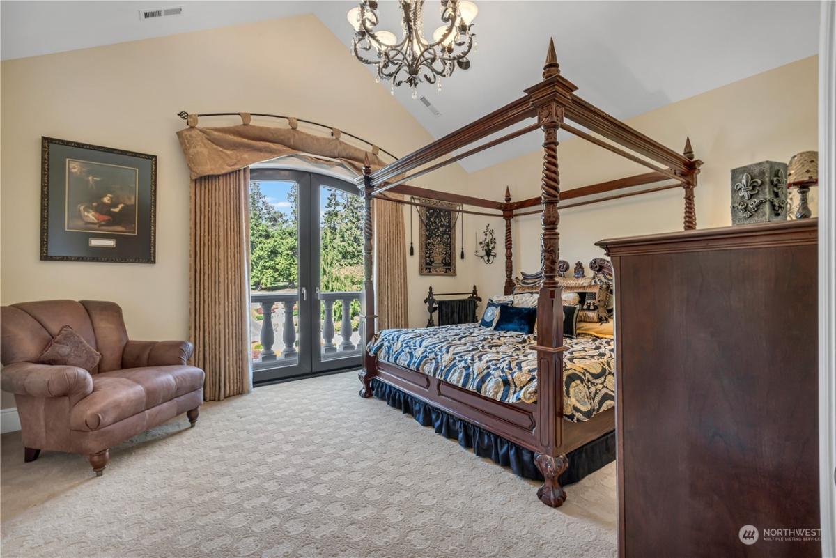 Bathroom with a chandelier, couch and glass doors.