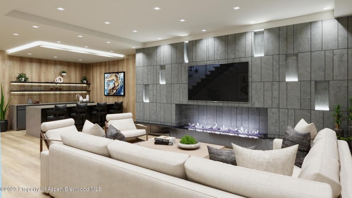 Living room with couches, wooden floor and a TV.