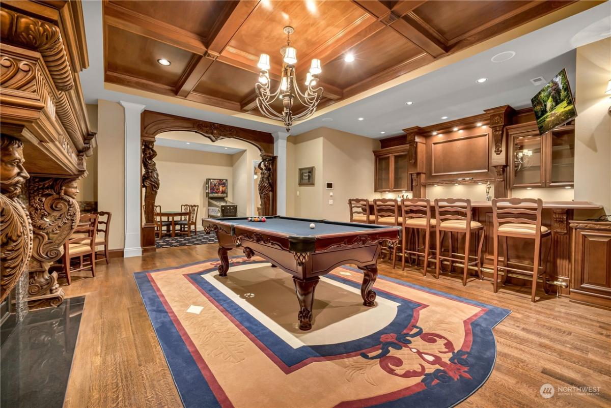 Recreational room with billiards table and a bar.