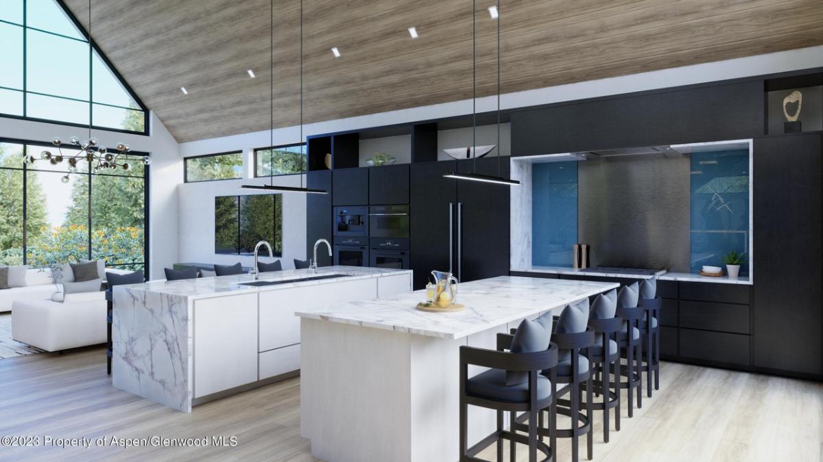 Kitchen with a large island, wooden floor and glass walls.