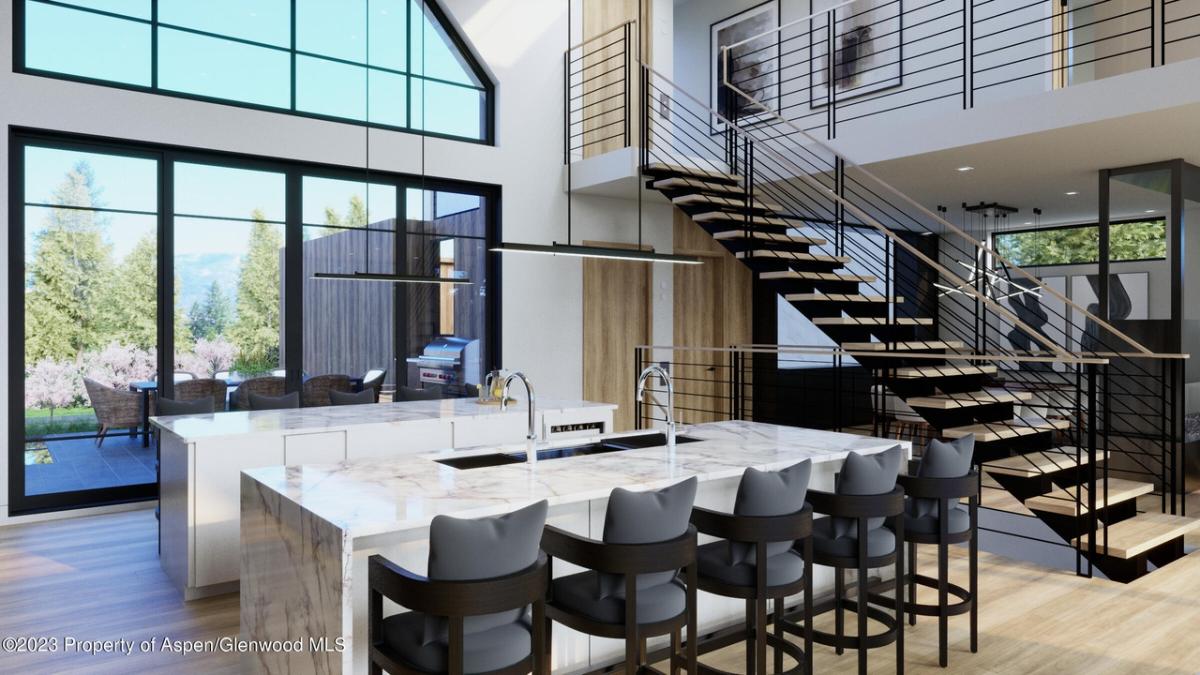 Kitchen with a large island, wooden floor and glass walls.