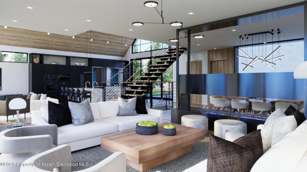 Living room with couches, TV, staircase, and custom lights.