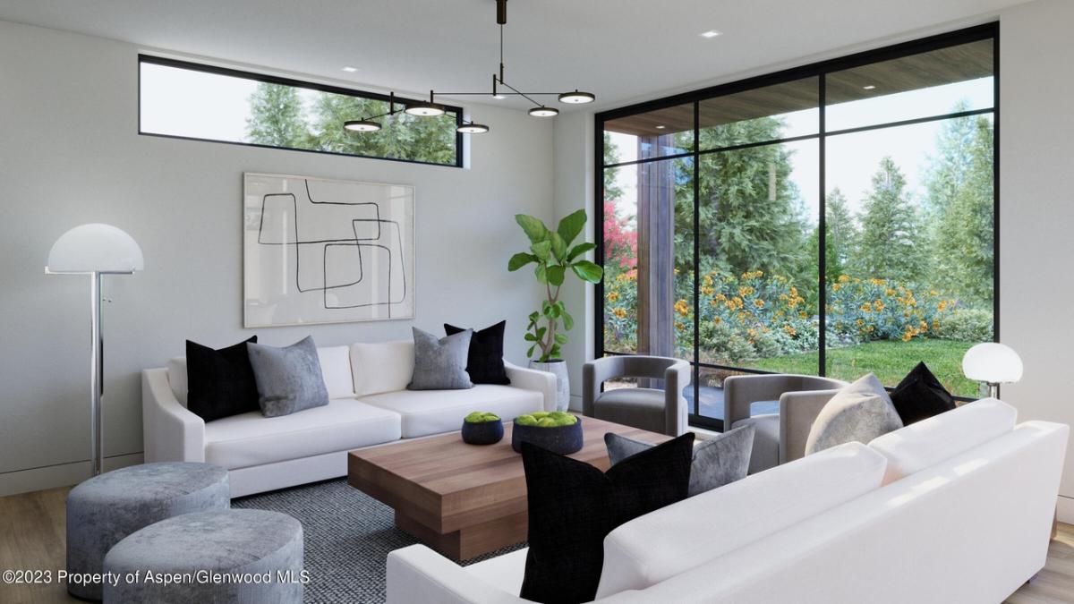 Family room with couches and glass walls.