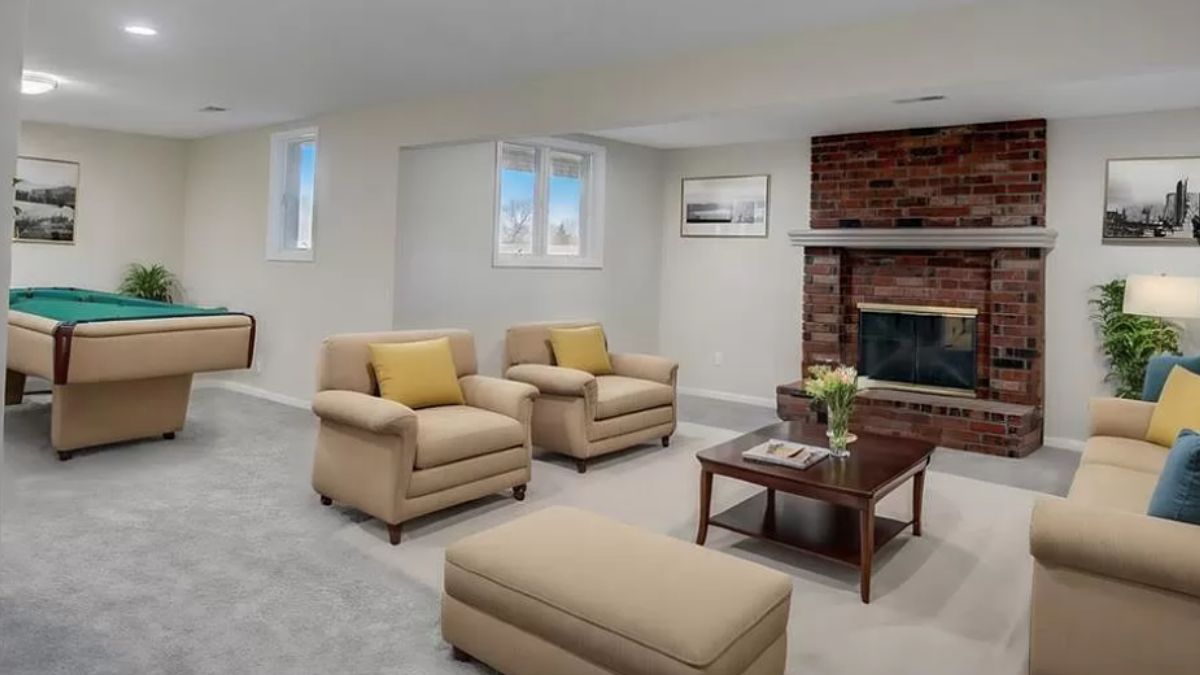 A family room with a fireplace, windows, a pool table, couches, and a center table.