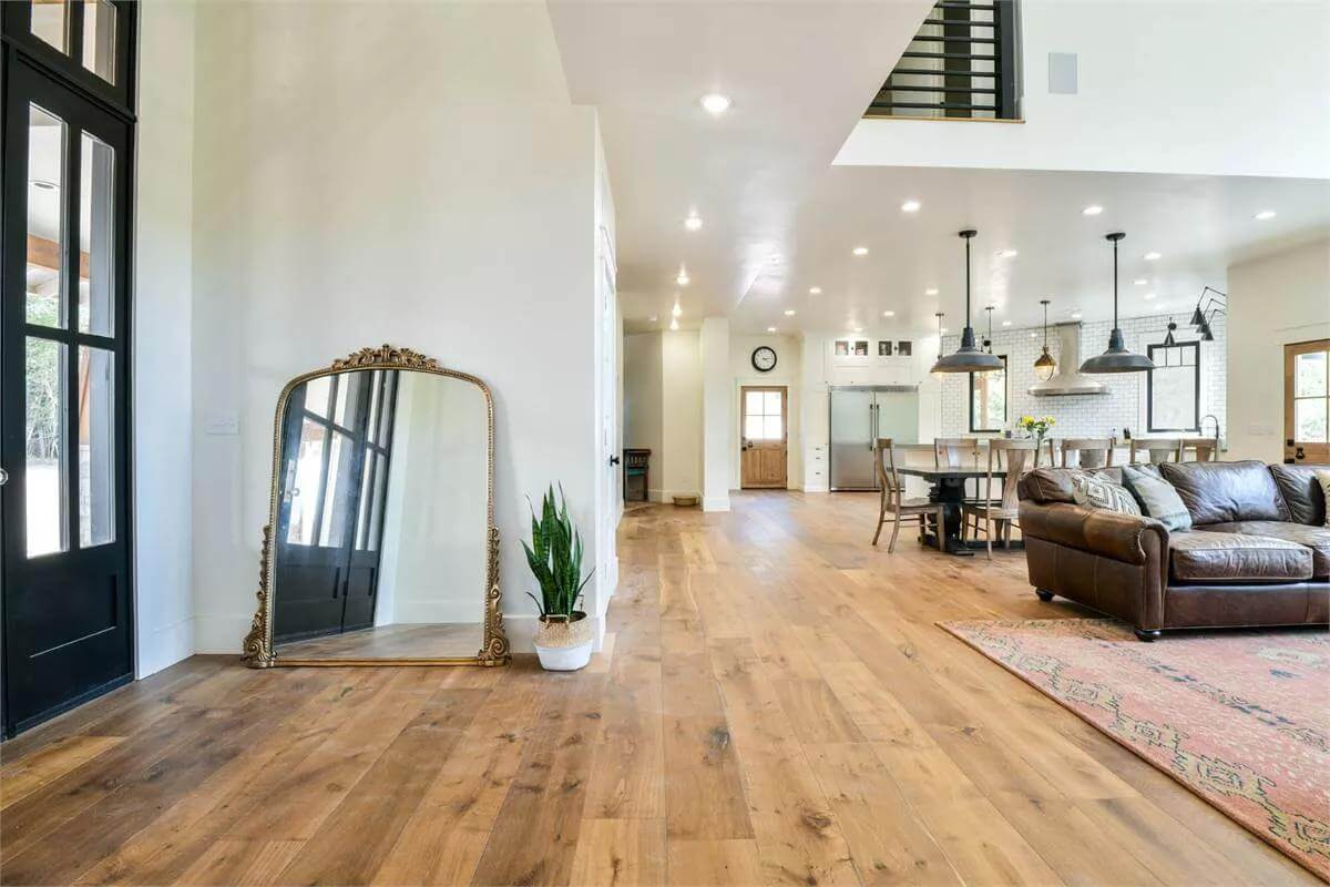 Foyer with a French front door and a large arched mirror.