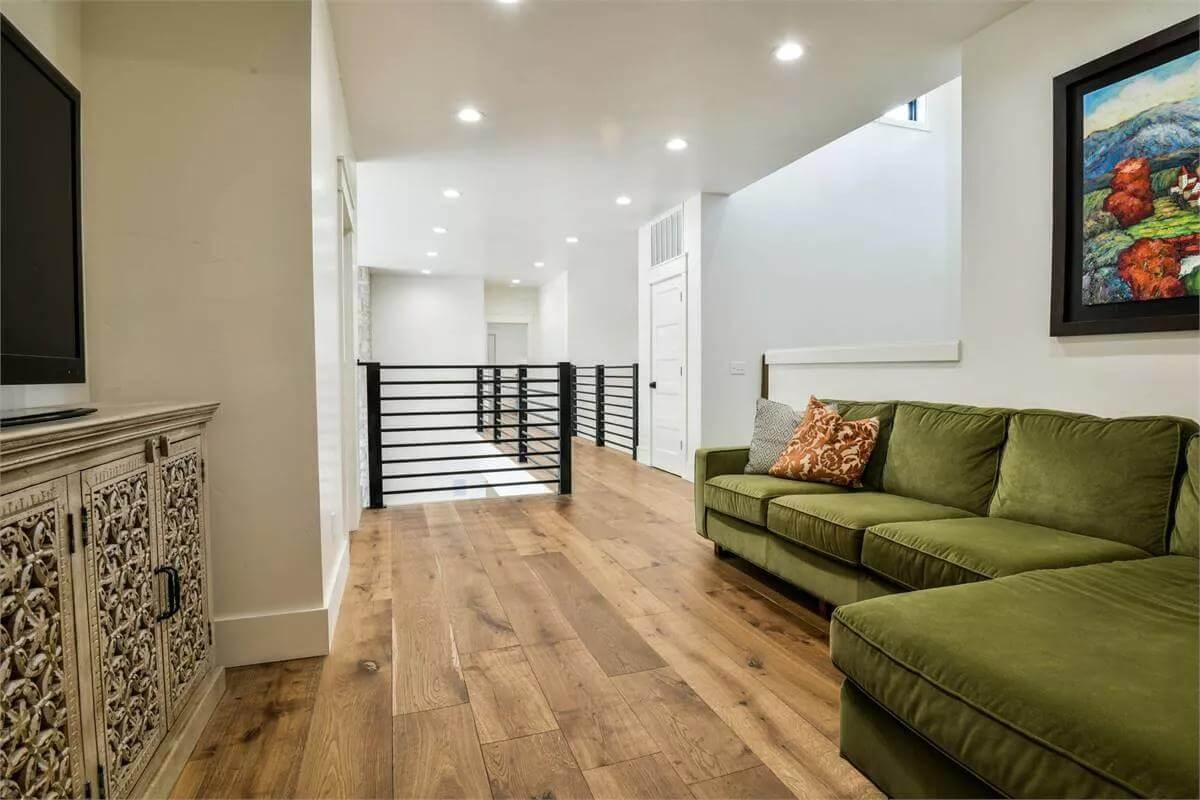 Family room with an L-shaped sectional and a wall-mounted TV.