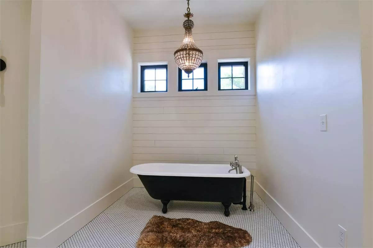 Primary bathroom with a clawfoot tub and clerestory windows.