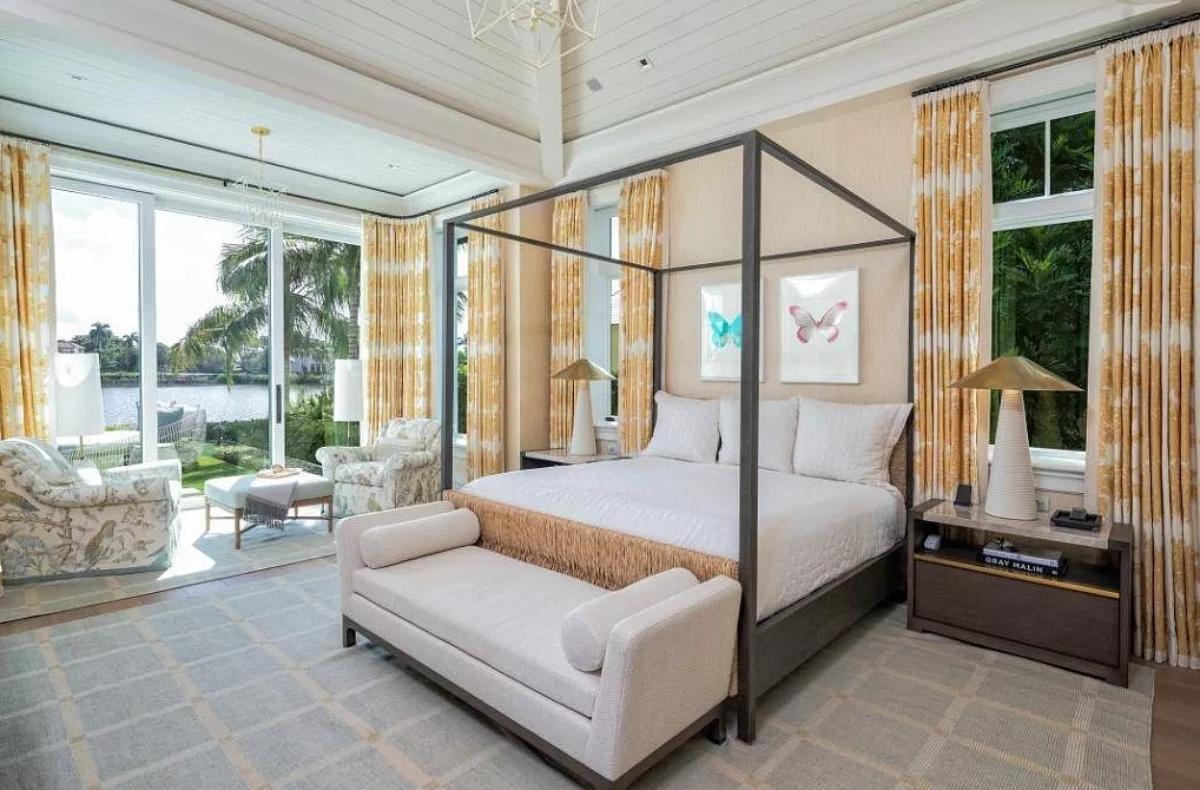 Bedroom with a large bed and a sliding glass door.