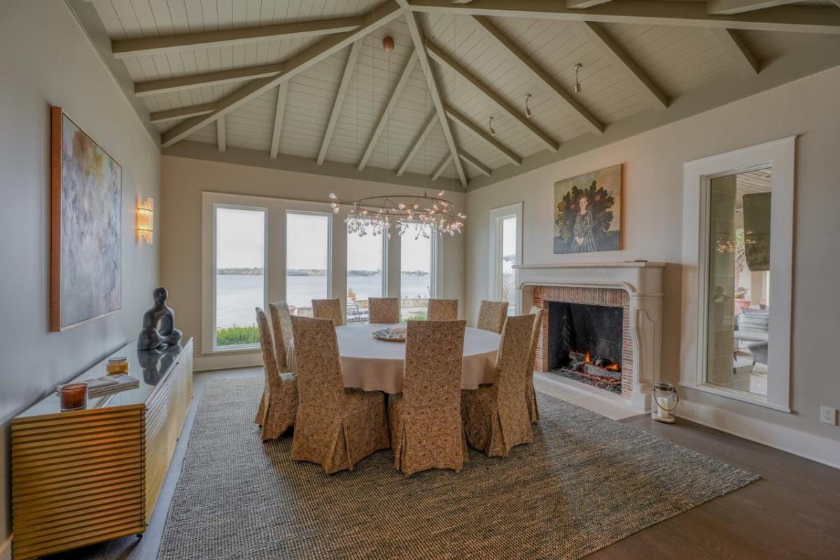 Dining room with glass windows and a fireplace.