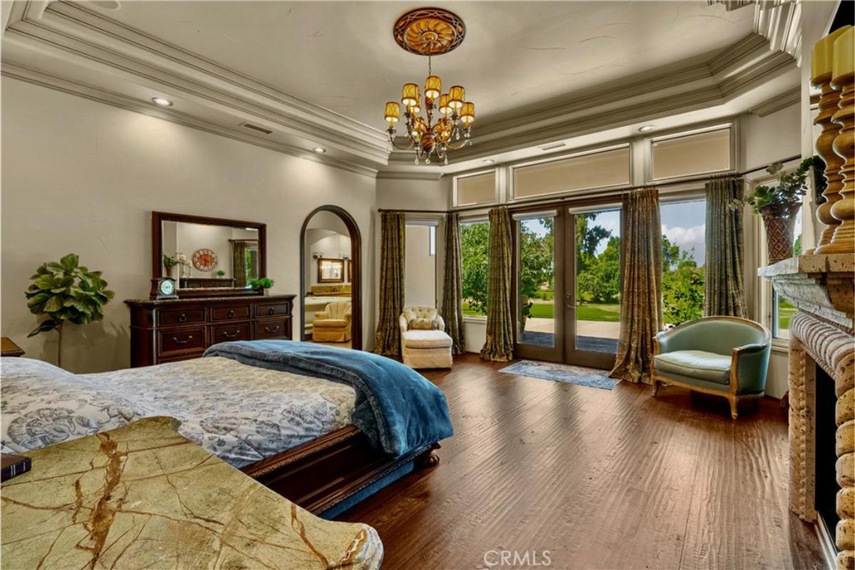 Bedroom with hardwood flooring and glass doors.