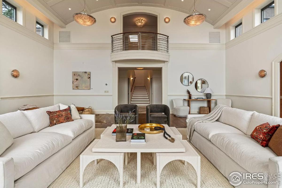 Living room with couches and custom lighting.