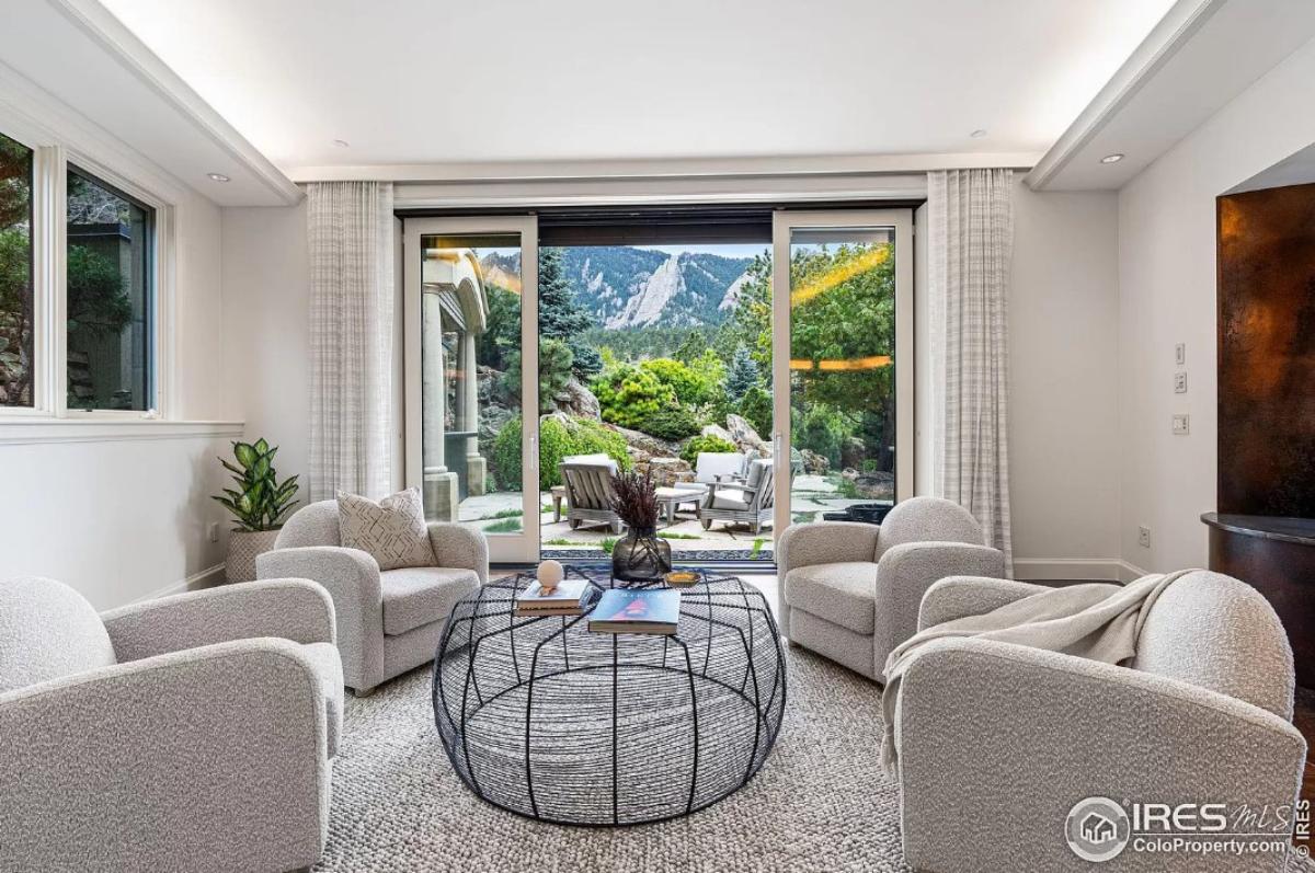 Sitting area with carpet flooring and sliding glass doors.