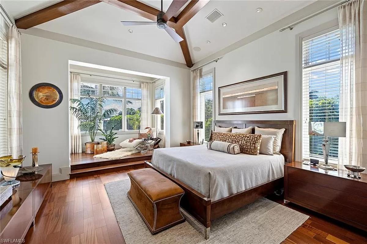 Bedroom with hardwood floors and glass windows.