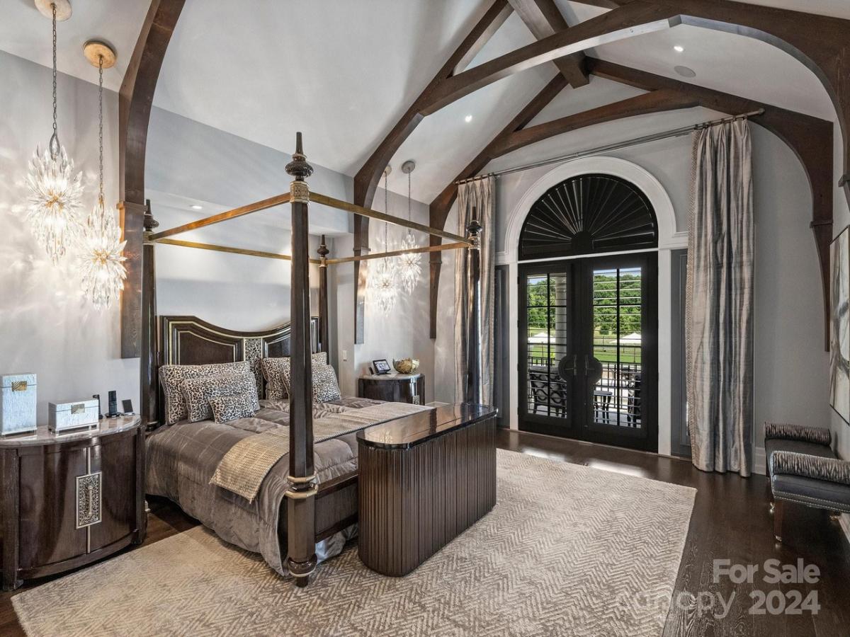 Bedroom with a large bed and hardwood flooring.