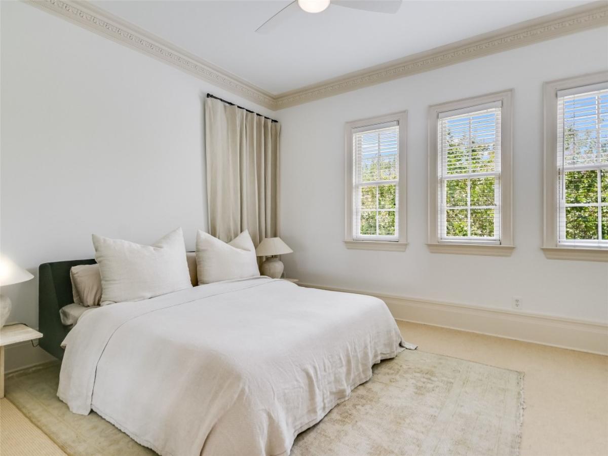 Bedroom with a large bed and carpet flooring.