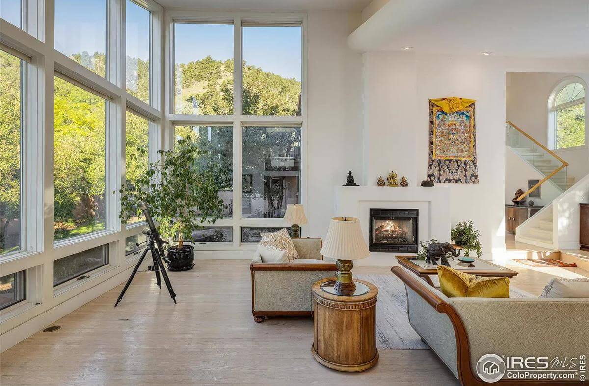 Floor-to-ceiling windows flood the living room with natural light.