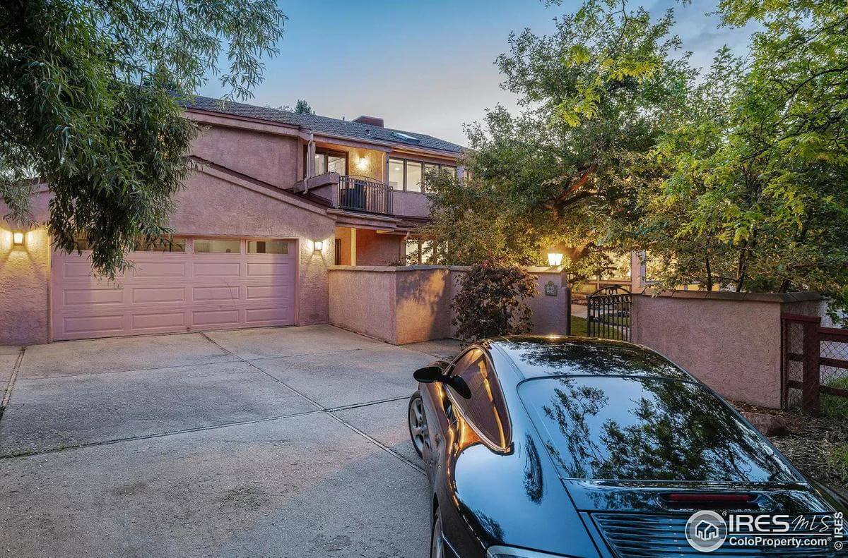 Garage with a large paneled door and a concrete driveway.