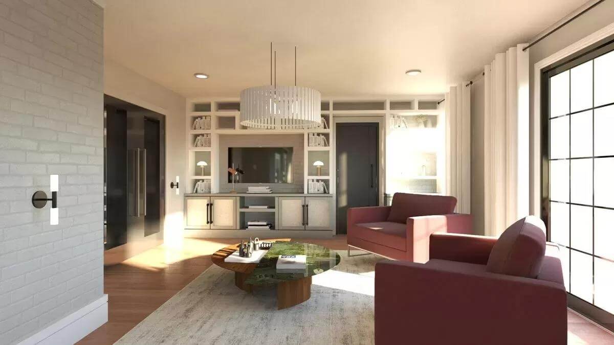 Living room with a TV, red chairs, and a round coffee table over the area rug.