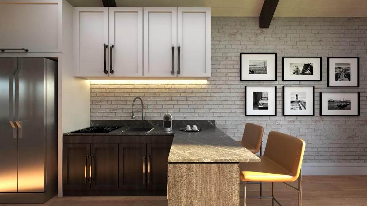 The kitchenette includes white and dark wood cabinets, slate appliances, and marble countertops.