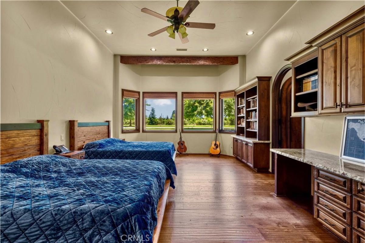 Bedroom with hardwood flooring and glass windows.