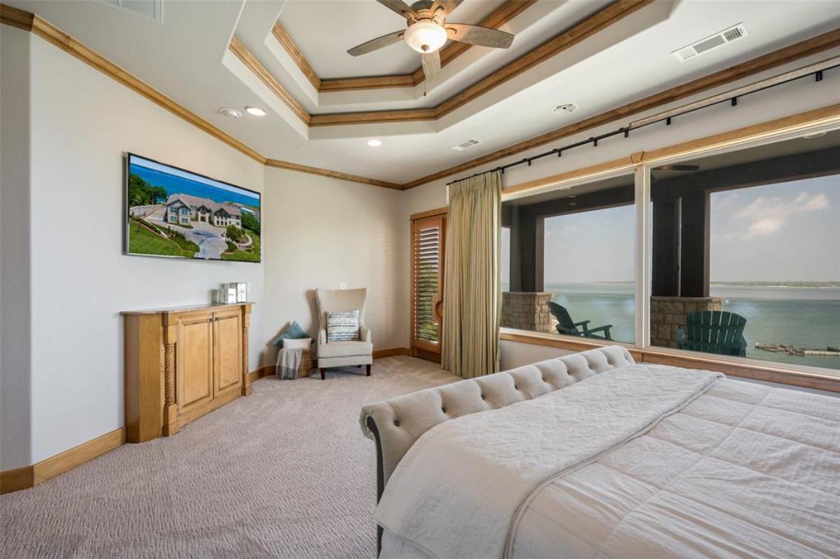 Bedroom with carpet flooring and glass windows.