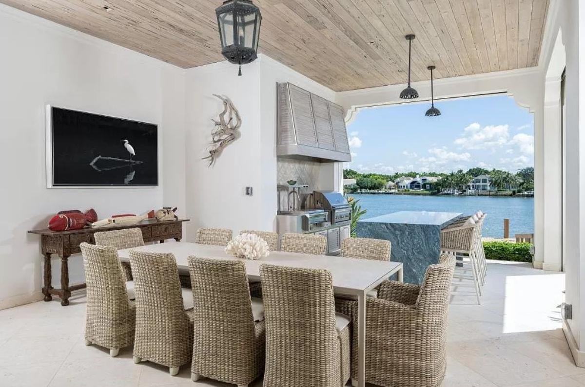 Grill area with a dining table and chairs.