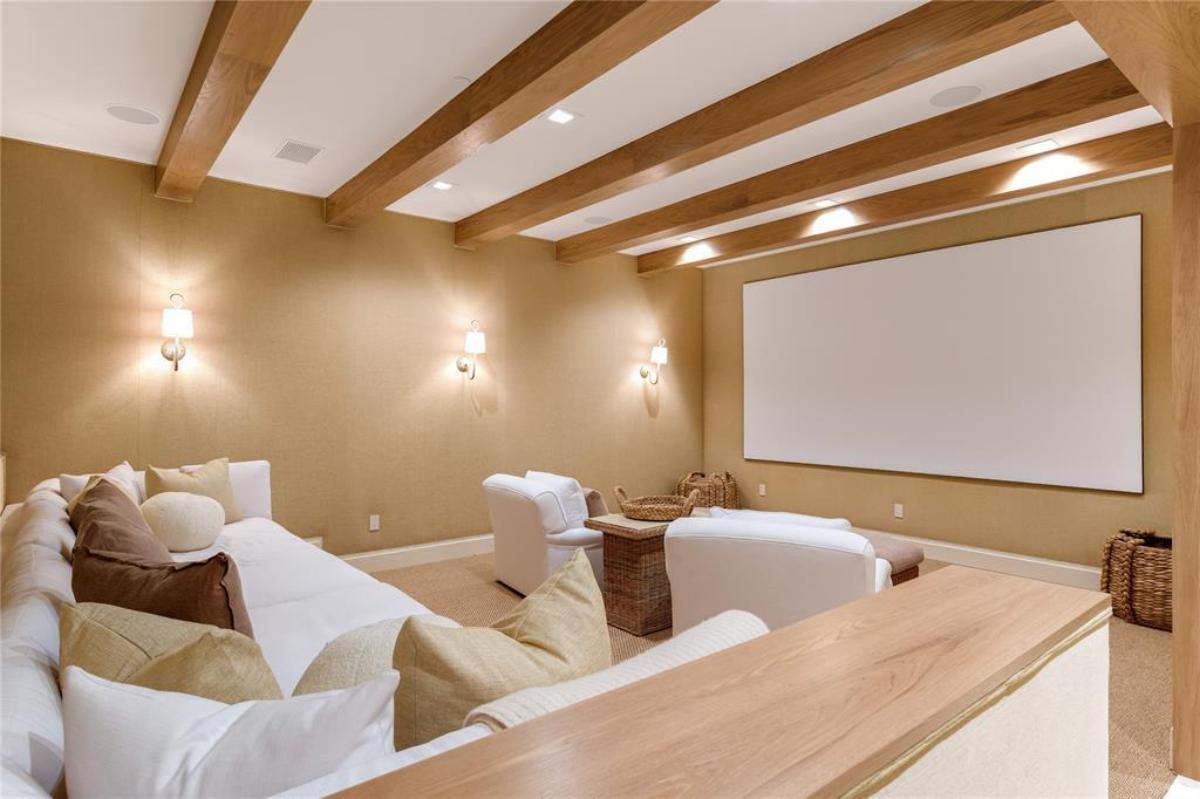 Home theater with couches and a vaulted ceiling.