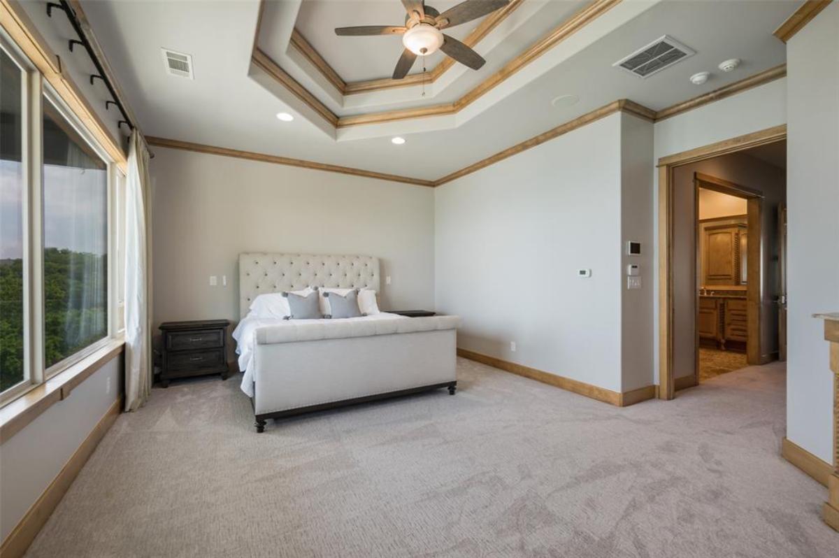 Bedroom with carpet flooring and glass windows.