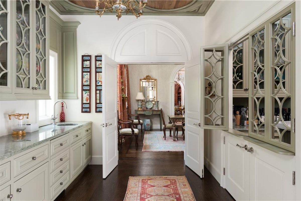 A kitchen with countertop, sink, and cabinets.