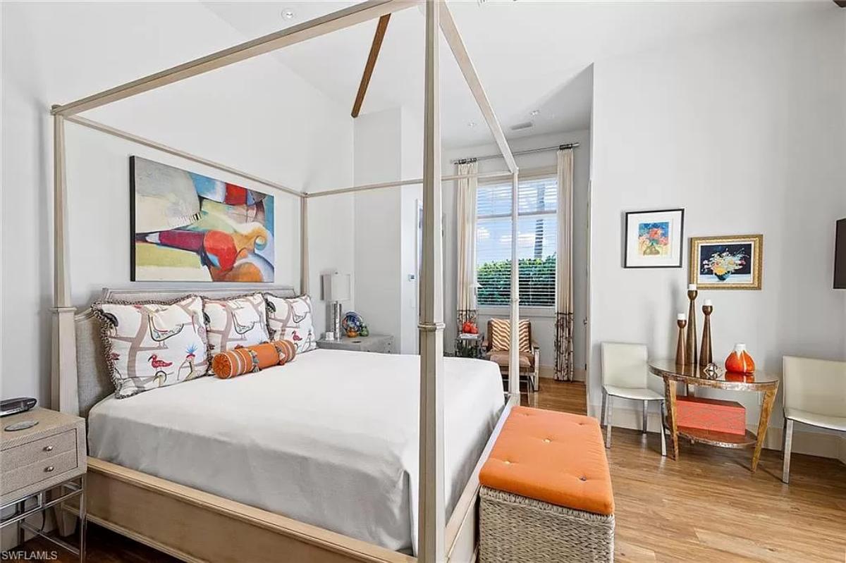 Bedroom with hardwood floors and a large bed.