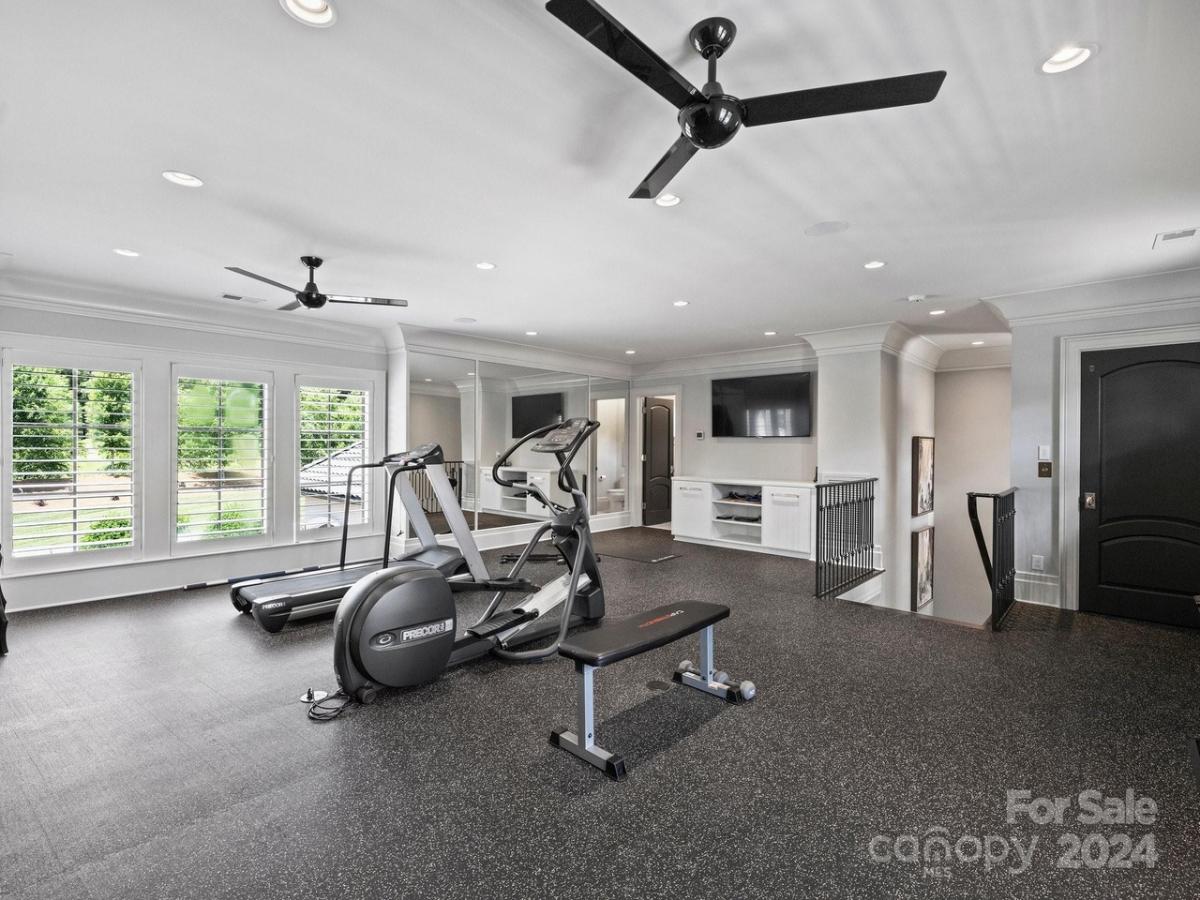 Home gym with a TV.