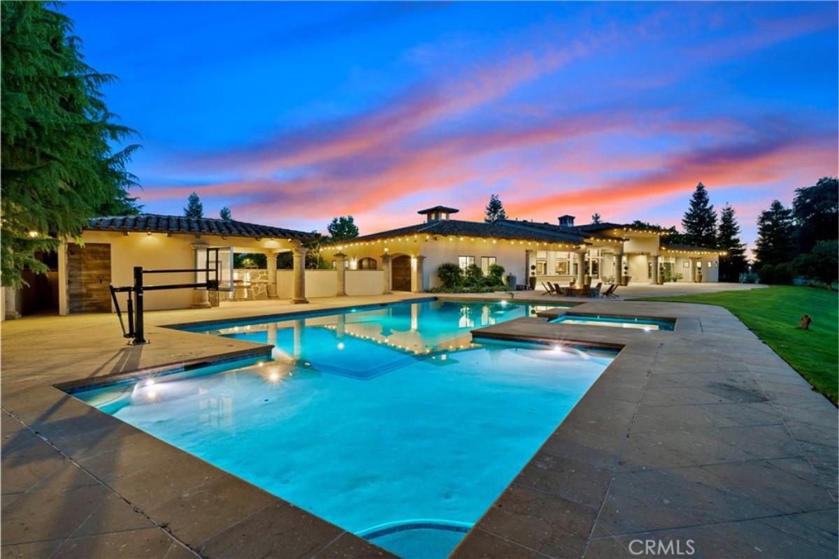 Rear view of the mansion with a pool.