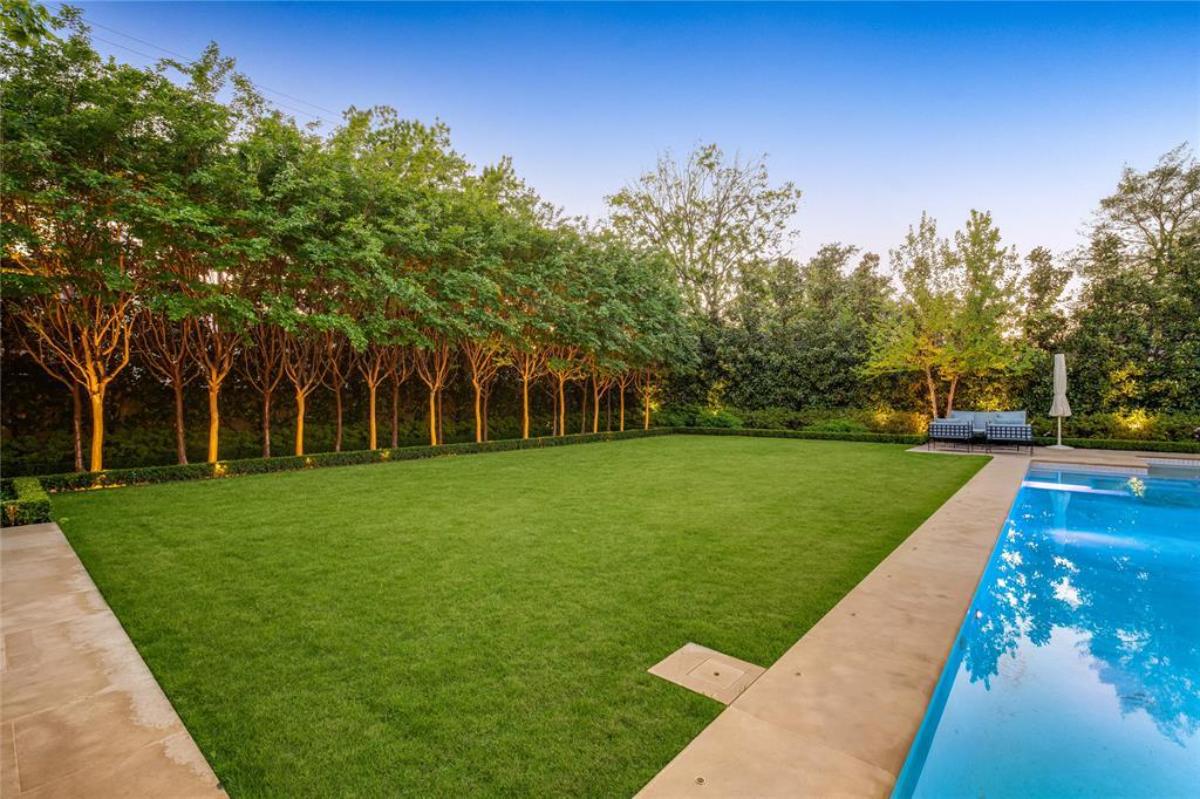 Pool with a large green lawn.