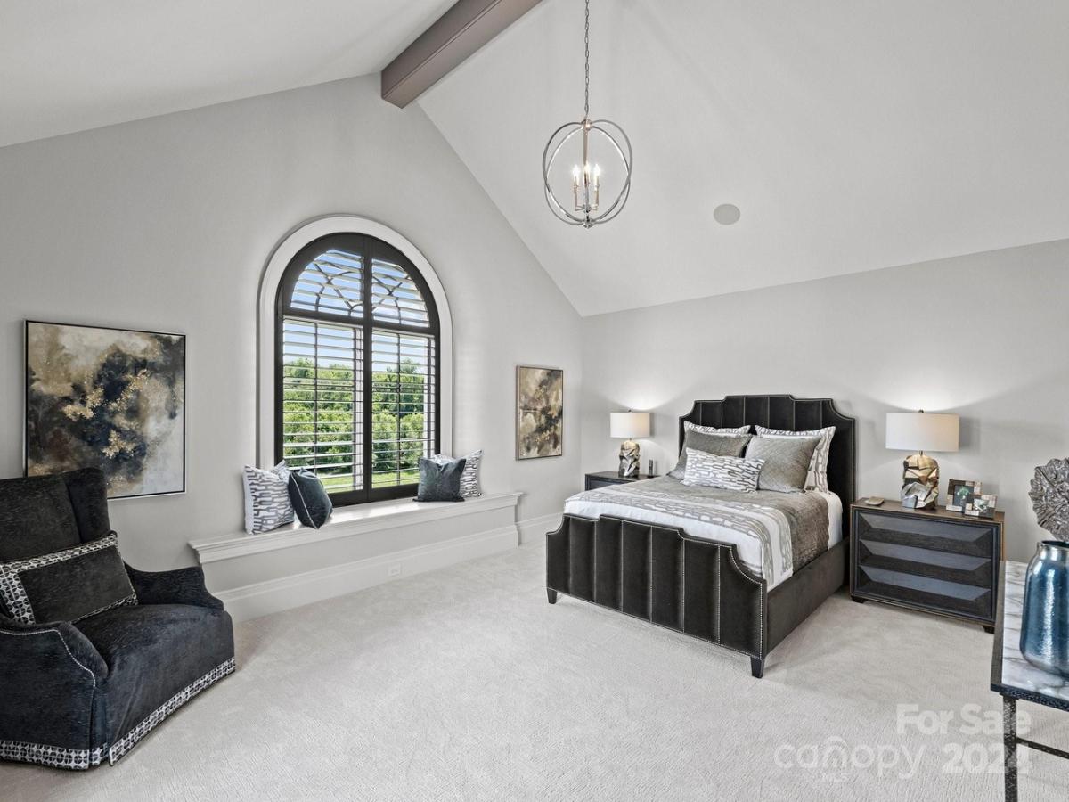 Bedroom with a couch and carpet flooring.