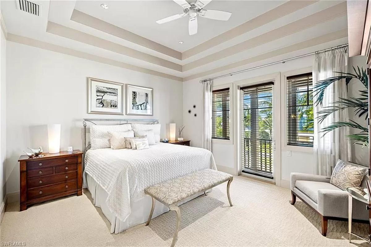 Bedroom with a large bed and carpet flooring.