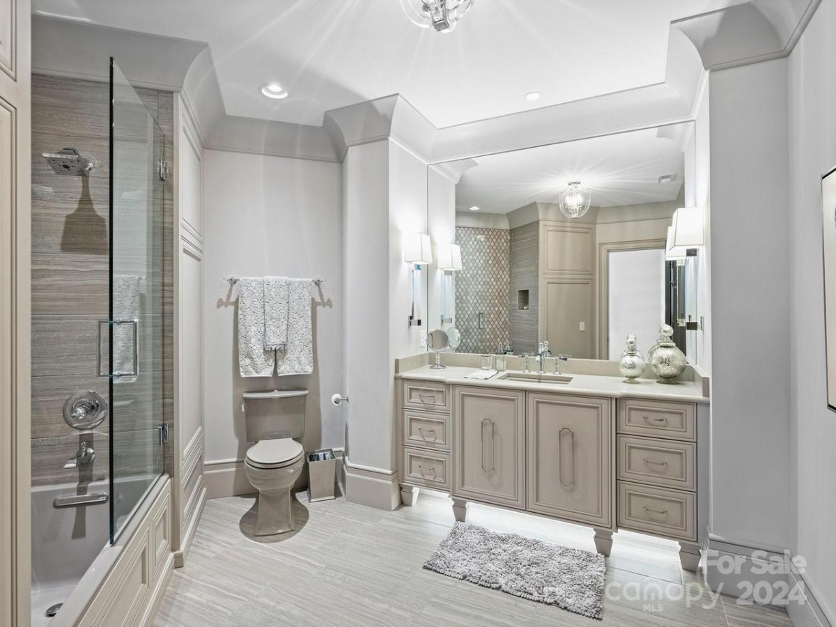 Bathroom with a sink, toilet and a walk-in shower.