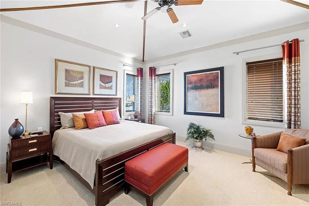 Bedroom with a large bed and carpet flooring.