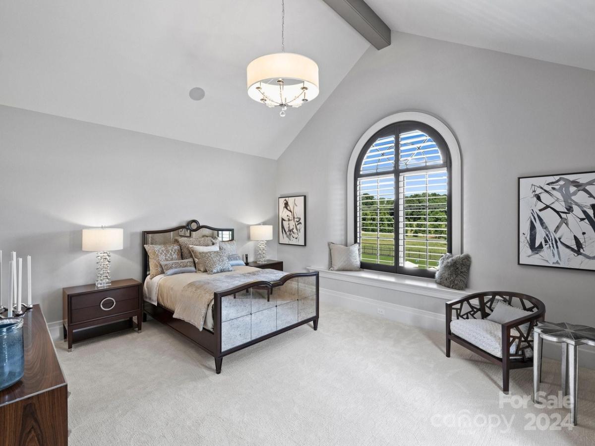 Bedroom with bedside lamps and carpet flooring.