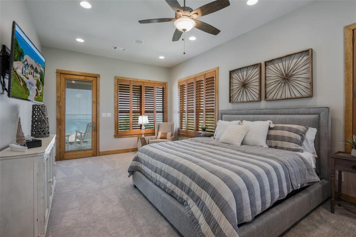 Bedroom with carpet flooring and a glass door.