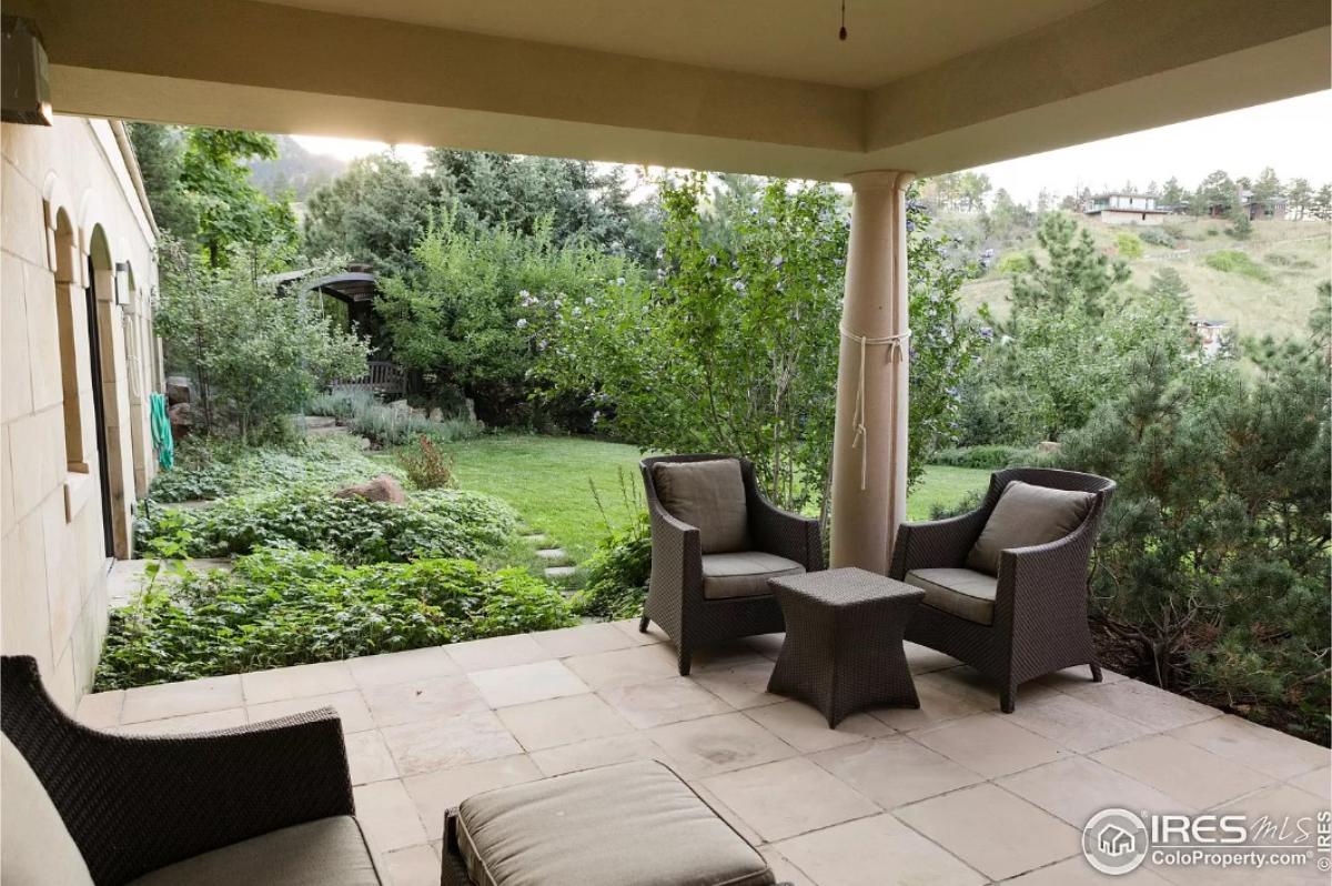 Covered patio with tables and chairs.