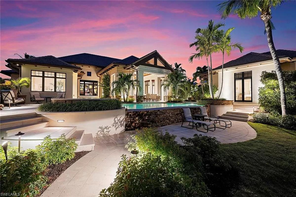 Rear view of the mansion with a pool.