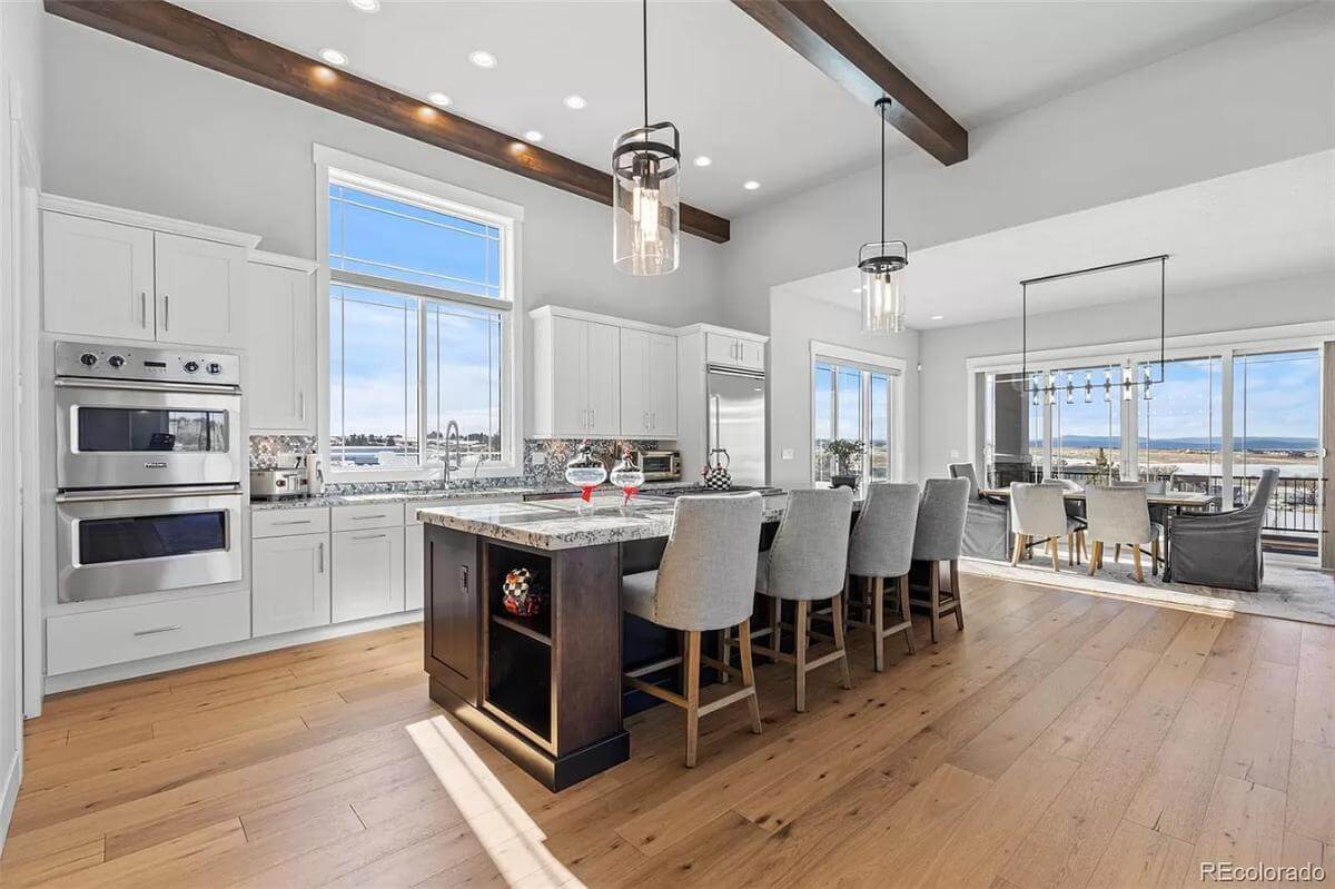 Kitchen with white cabinetry, stainless steel appliances, and a breakfast island.