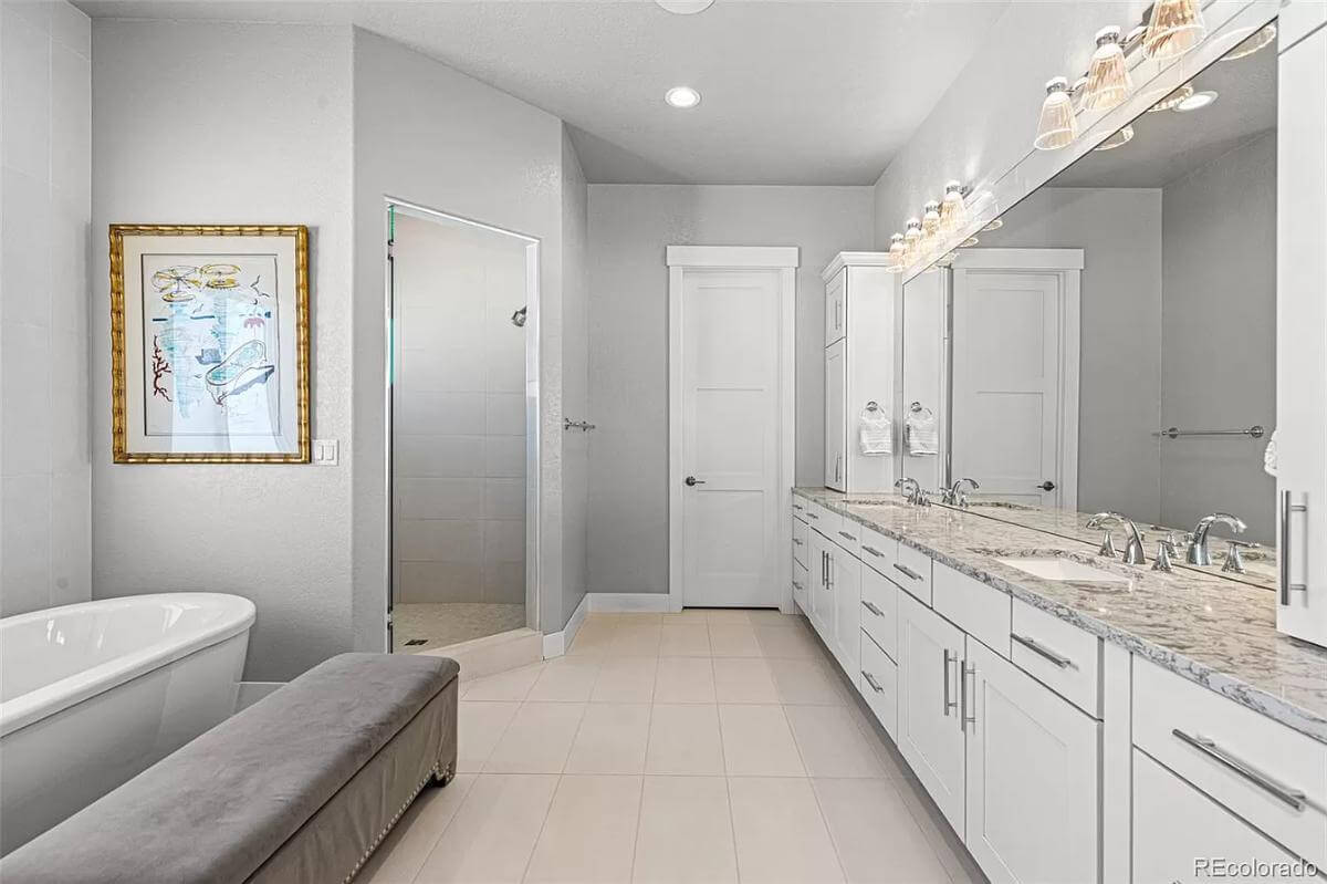 Primary bathroom with a soaking tub, a dual sink vanity, and a corner shower.